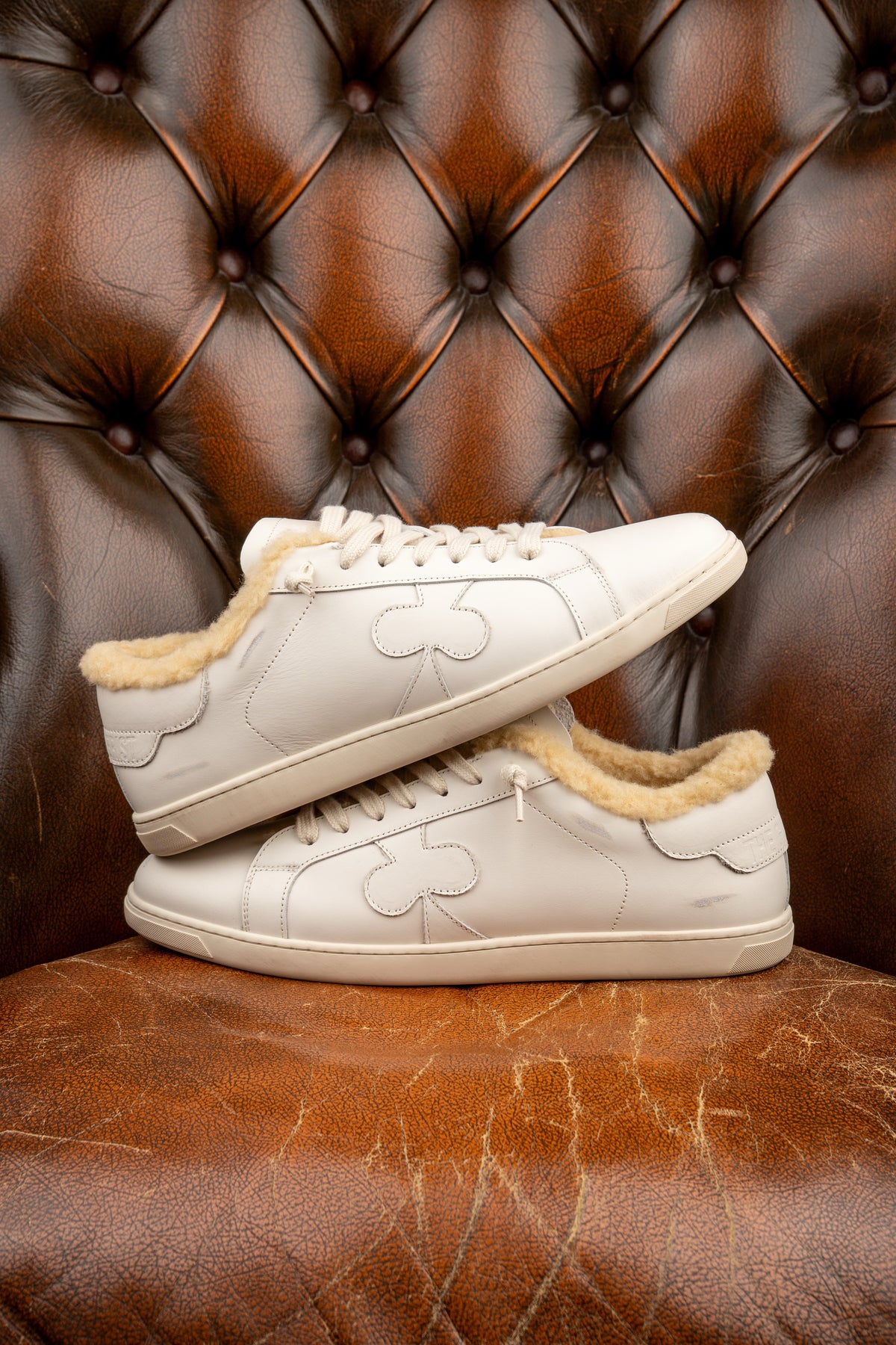 Geneva Wool Whiteout, pair stacked on a chesterfield chair