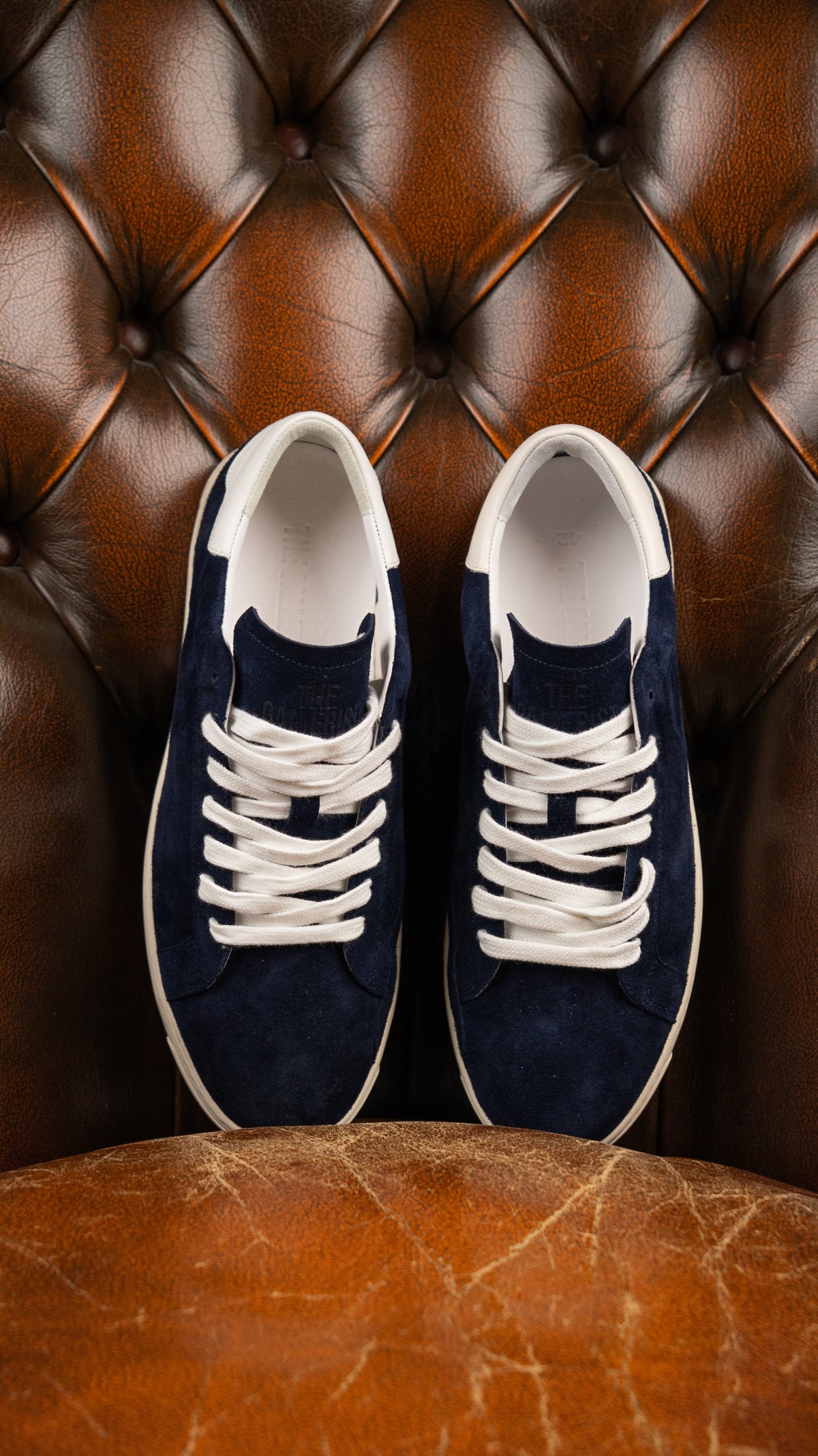 Geneva Dark Blue Unsigned, pair from above on a chesterfield chair