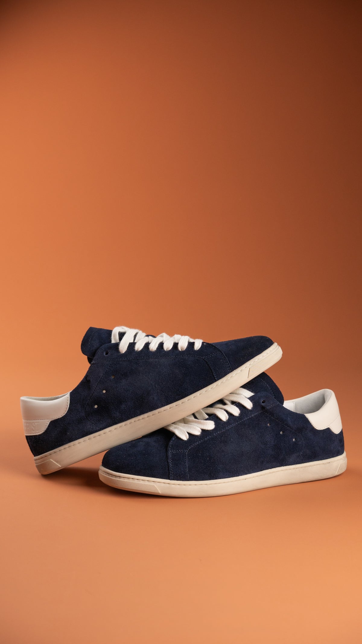 Geneva Dark Blue Unsigned, pair stacked against an orange backdrop