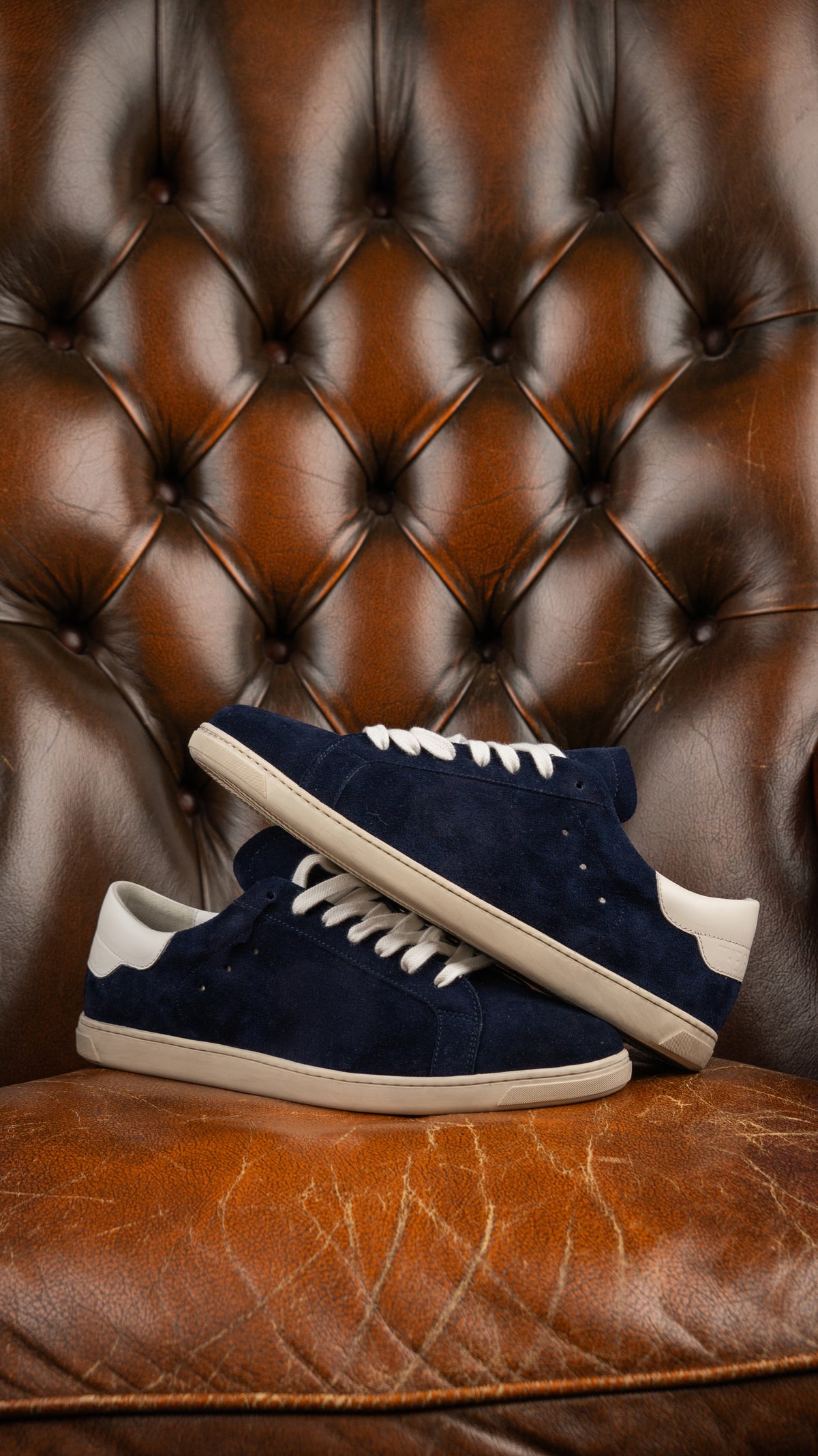 Geneva Dark Blue Unsigned, pair stacked on a chesterfield chair