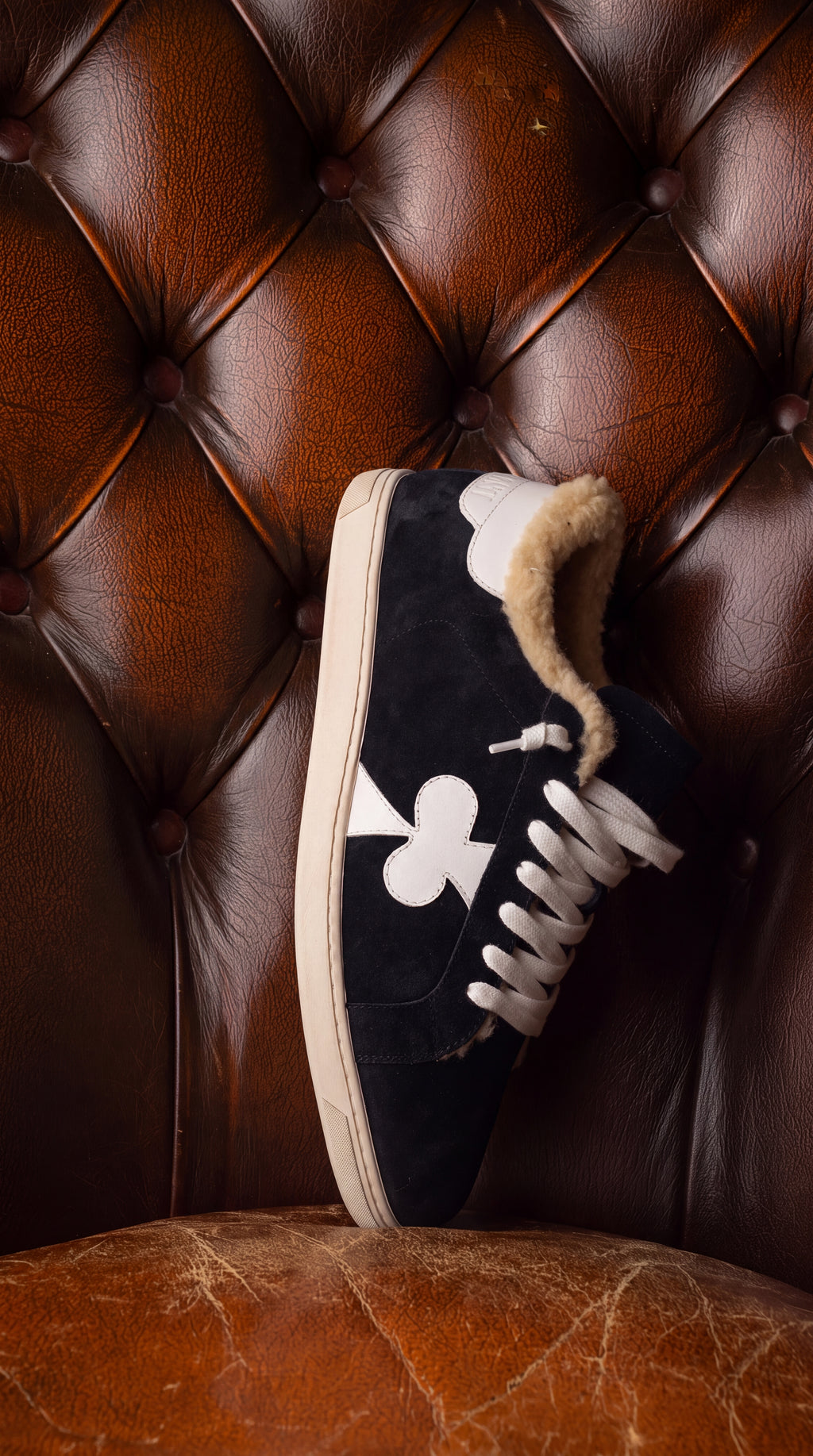 Geneva Wool Black Suede, on a chesterfield chair