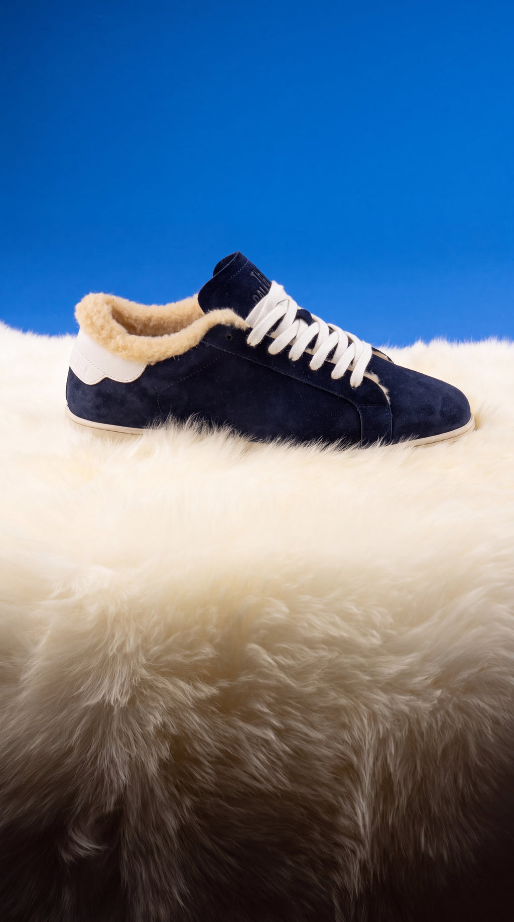 Geneva Wool Dark Blue Unsigned, on sheepskin against a blue backdrop