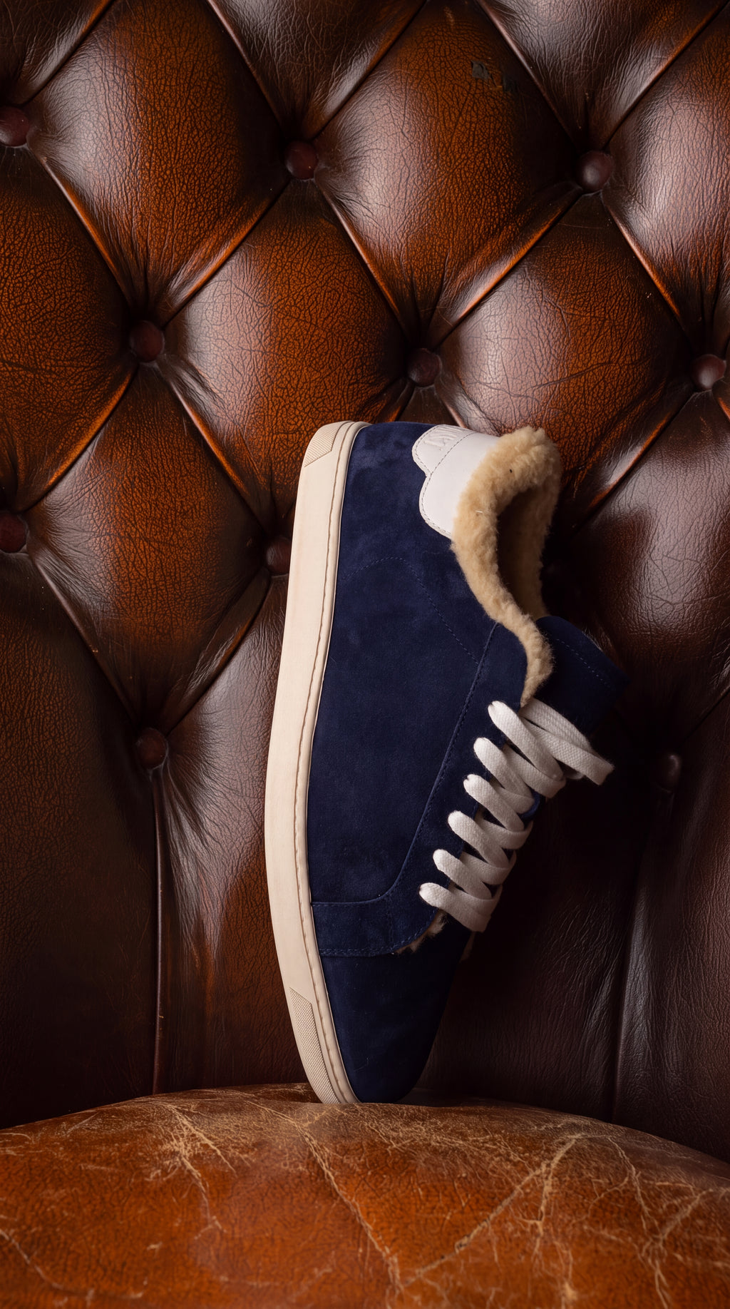 Geneva Wool Dark Blue Unsigned, on a chesterfield chair