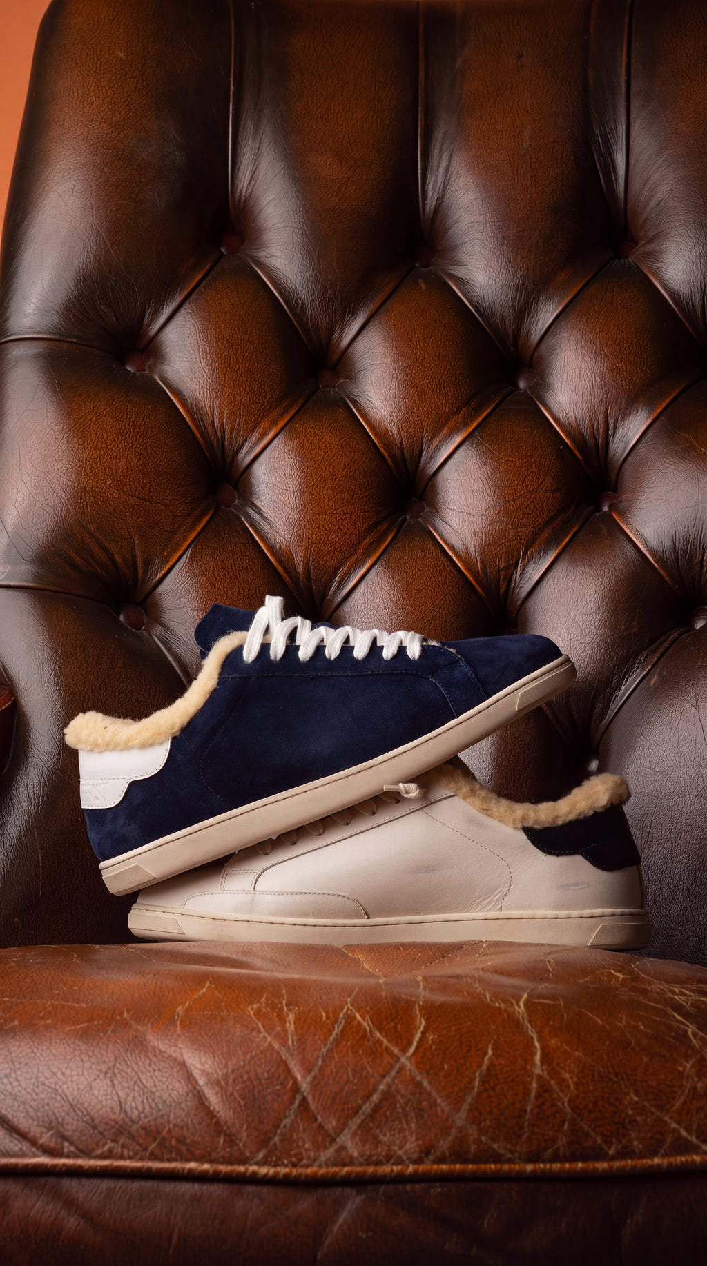 Geneva Wool Dark Blue Unsigned, stacked on a chesterfield chair