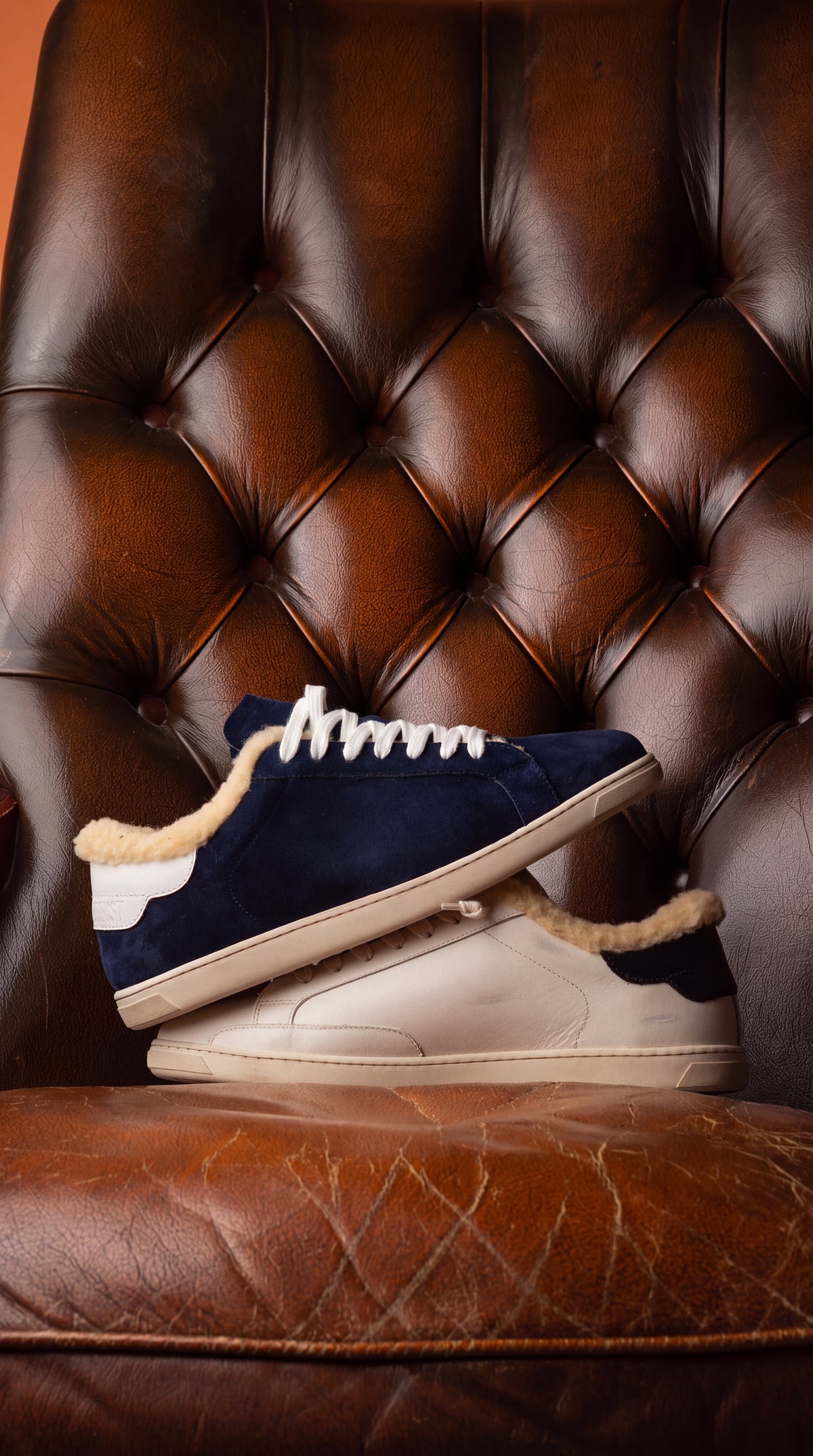 Geneva Wool Dark Blue Unsigned, stacked on a chesterfield chair